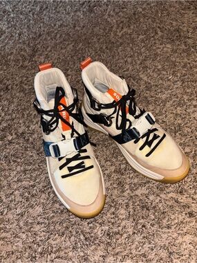 Beige High-Top SOREL hiking boots with Black Accents and Orange Pull Tabs